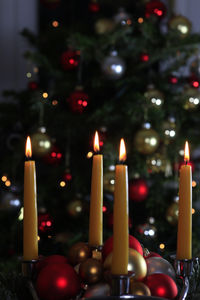 Close-up of illuminated candles against blurred background