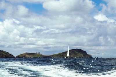 Sailboat in sea against sky