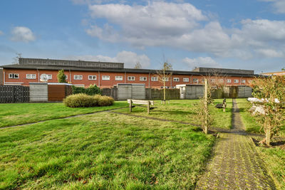 Houses on field against sky