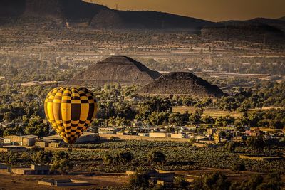 View of hot air balloons on field