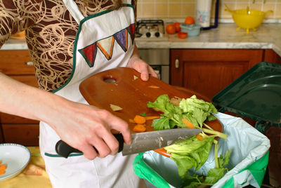 Midsection of woman having food at home