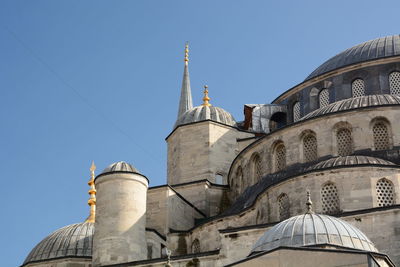 Low angle view of building against clear blue sky