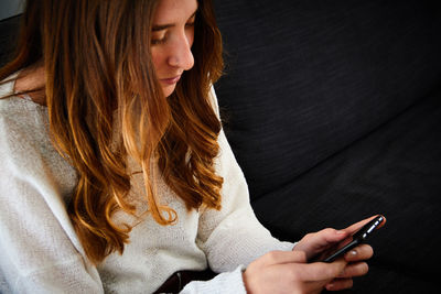 Midsection of woman using mobile phone