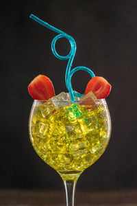 Close-up of wine glass against black background