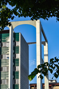 Low angle view of modern building against blue sky