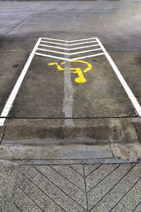 High angle view of arrow sign on road