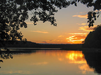 Scenic view of lake against orange sky