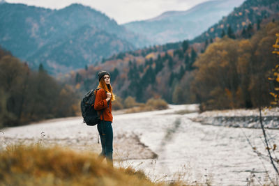 Woman standing on mountain during winter