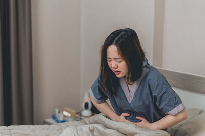 Portrait of young woman sitting at home