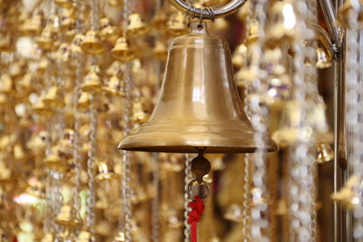 Close-up of electric lamp hanging in temple