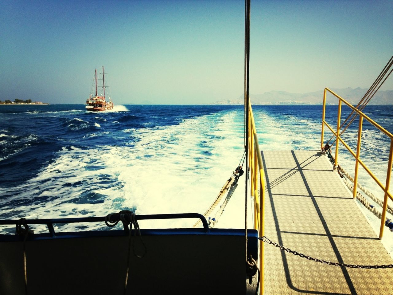 sea, water, horizon over water, nautical vessel, transportation, mode of transport, boat, clear sky, blue, sky, scenics, travel, beauty in nature, nature, sunlight, rippled, sailing, railing, tranquil scene, tranquility