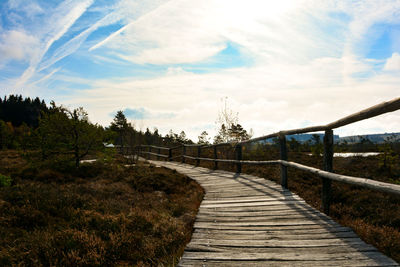 Footpath by bridge against sky, in the black moor in the rhön, germany 