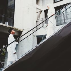 Side view of man standing on staircase