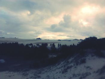 Scenic view of landscape against cloudy sky