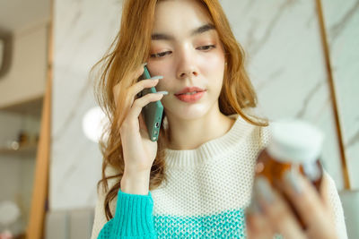 Portrait of young woman looking at camera