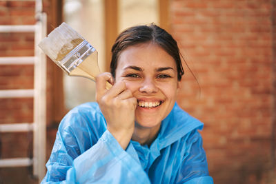 Portrait of young woman drinking water bottle