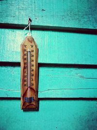 Close-up of cross hanging on wood