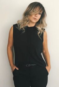 Portrait of woman standing against white background