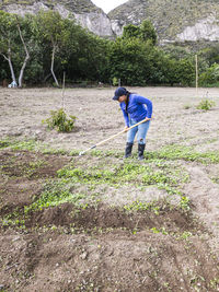 Rear view of man walking on field