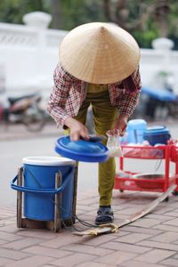 Rear view of man working on street