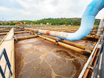 Pipe and walk bridge above waste water pool. sedimentation tank in a sewage treatment plant