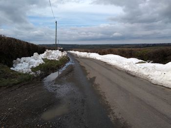 Road by sea against sky