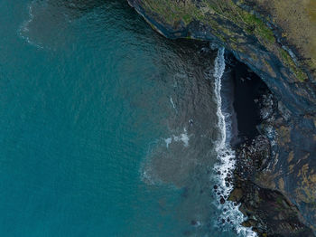 Iceland black sand beach with huge waves at reynisfjara vik.