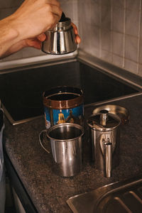 Cropped hand of woman making coffee 