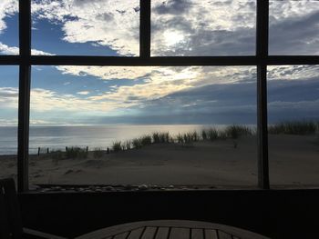 View of beach against cloudy sky