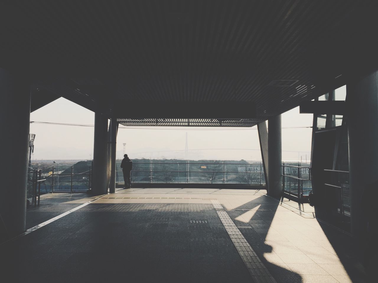 architecture, indoors, built structure, window, sunlight, architectural column, empty, ceiling, building exterior, glass - material, day, flooring, shadow, sky, column, absence, incidental people, corridor, building, interior