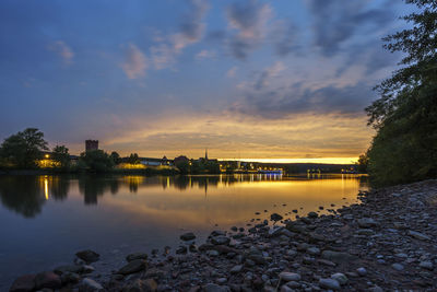 Scenic view of lake against sky during sunset