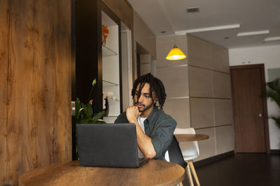 Freelancer working on laptop at home office