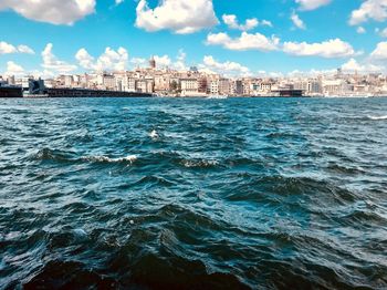 Scenic view of sea and buildings against sky