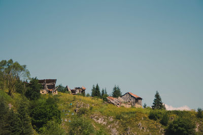 Houses on field against clear sky