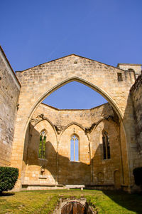 Arch of building against blue sky