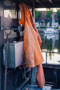 Rainwear, hoe, rope hanging on a fishing boat. 