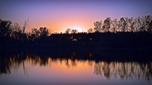 Scenic view of lake against sky at sunset