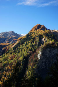 Scenic view of mountains against blue sky