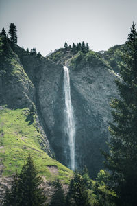 Low angle view of waterfall against sky