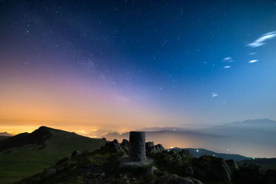 Scenic view of mountains against sky at night