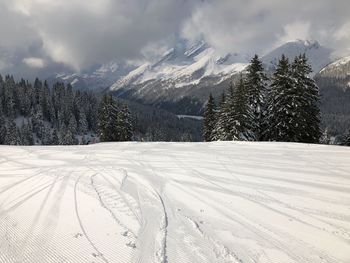 Scenic view of snow covered mountains against sky