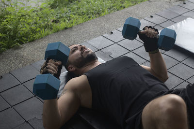 High angle view of man photographing mobile phone on floor