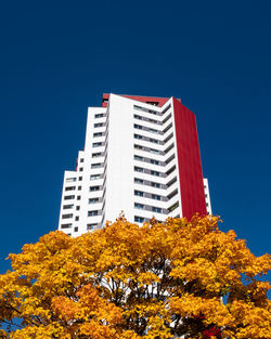 Low angle view of buildings against clear blue sky