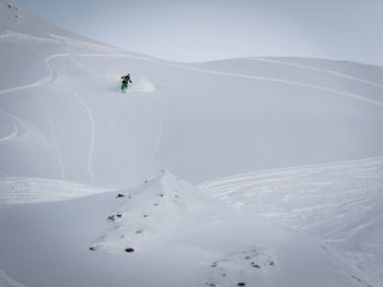Man skiing on snowcapped mountain