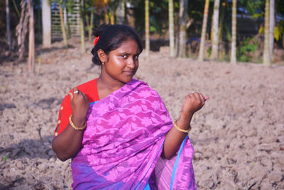 Girl looking away while standing on land