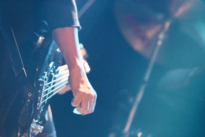 Woman playing guitar at music concert