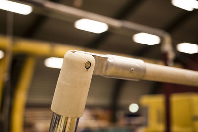 Close-up of electric lamp hanging on wood