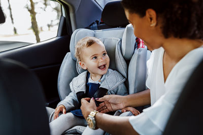 Mother and daughter sitting in car