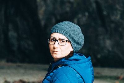 Close-up of woman wearing knit hat in forest