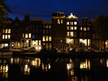 Reflection of buildings in water at night